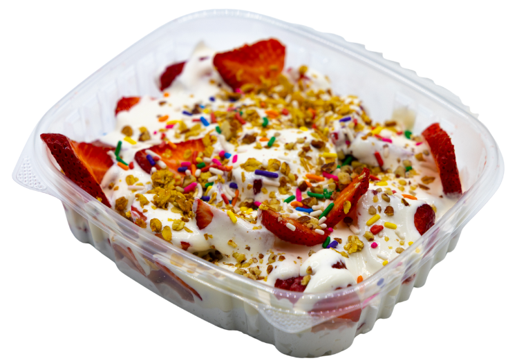 Slices of strawberries and bananas smothered in yogurt and topped with sprinkles and oats at Krazy Fruits.